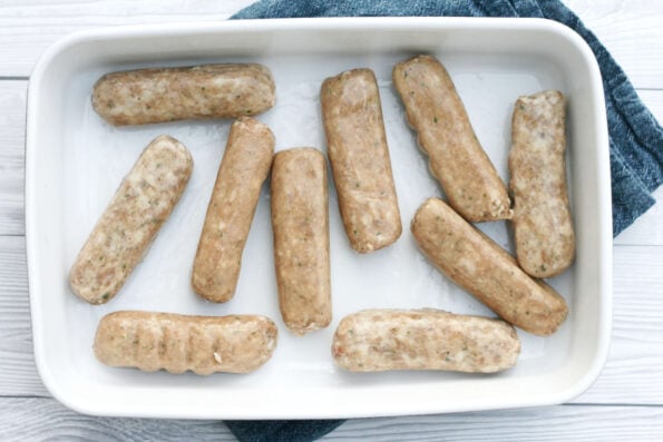 sausages arranged in a baking dish