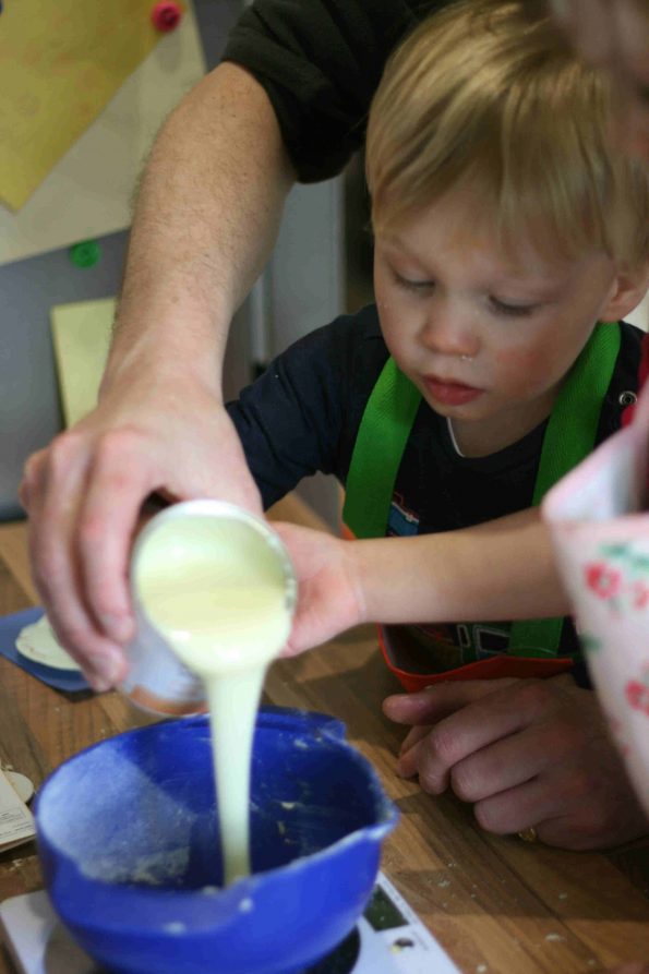 pouring condensed milk into a bowl