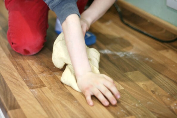 child kneading dough