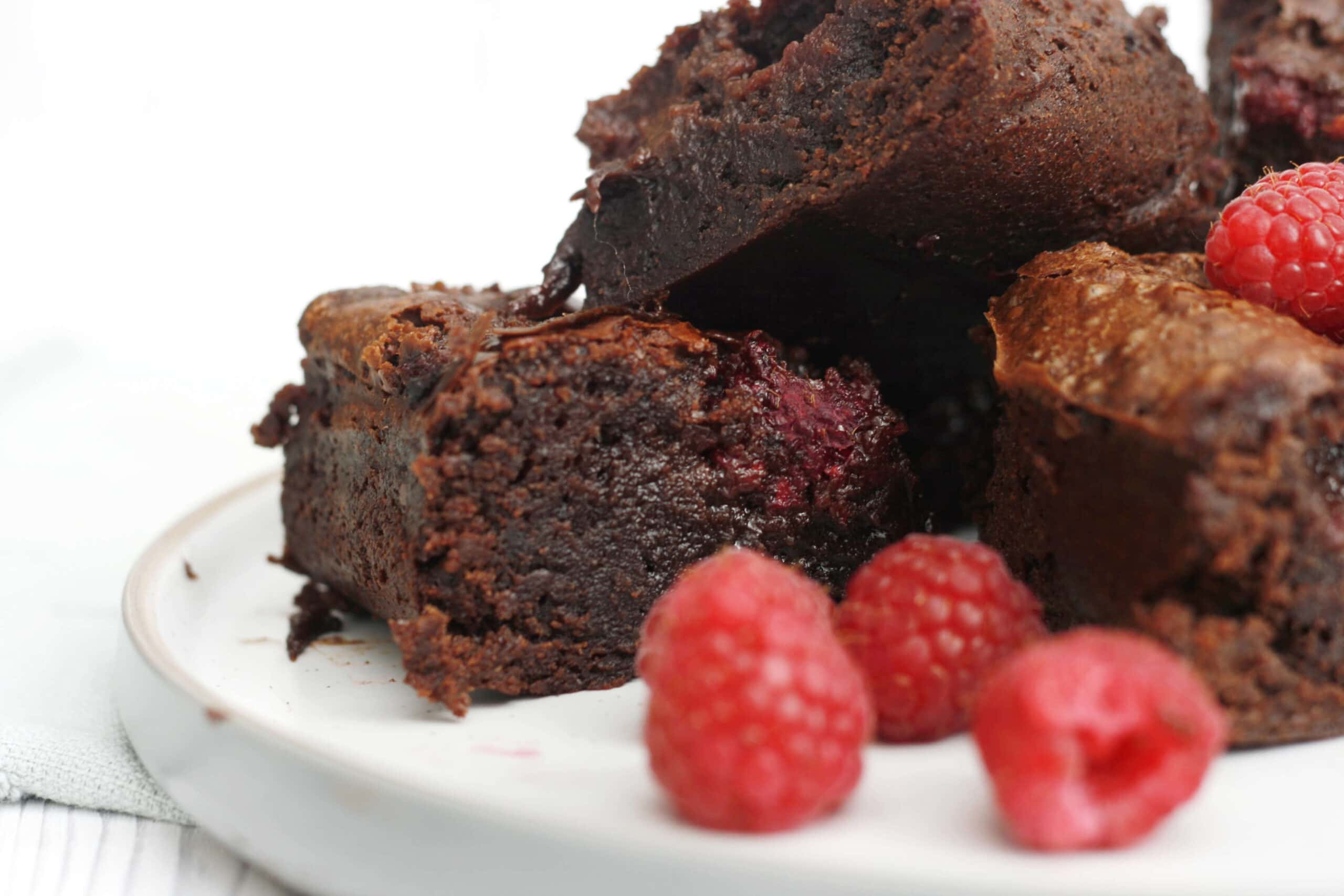 raspberry brownies on a serving plate