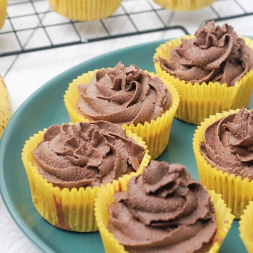 chocolate and banana cupcakes on a green plate.