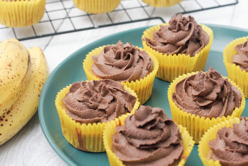 chocolate and banana cupcakes on a green plate.