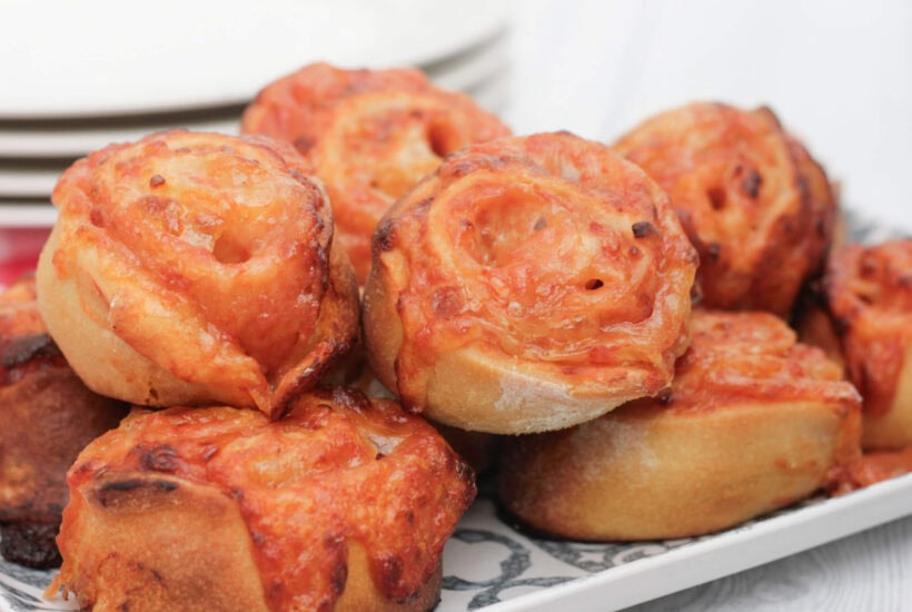 pizza pinwheels on a serving plate.