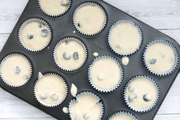 unbaked blueberry muffins in a muffin tin.