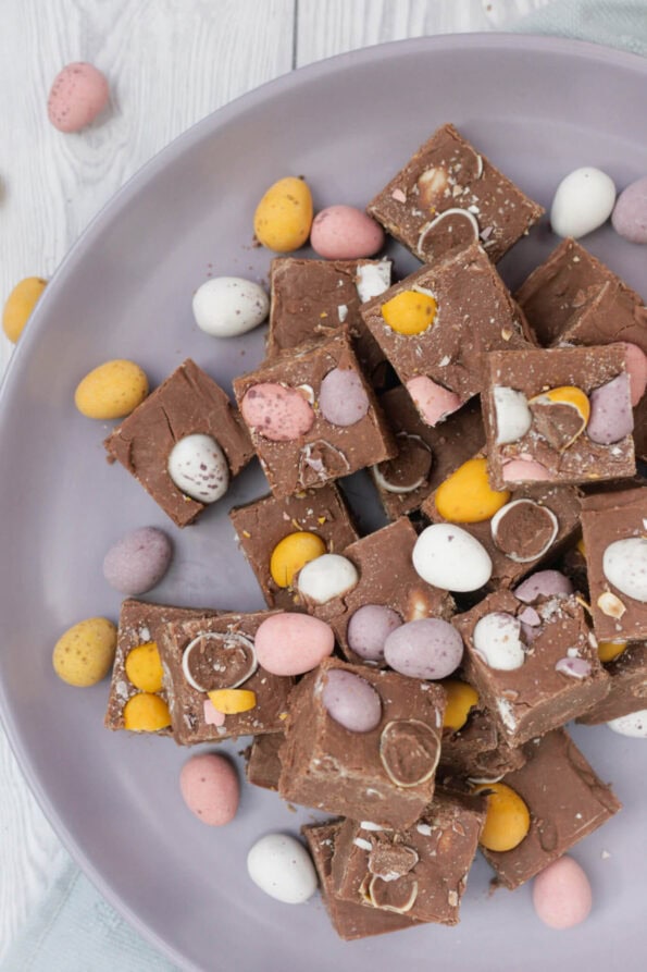 Mini Egg fudge pieces on a lilac plate.