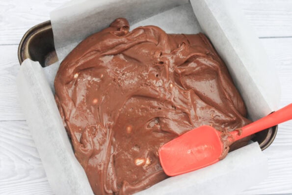 spreading fudge out in a baking tin.