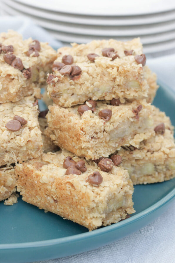 banana oatmeal bars stacked on a green plate.