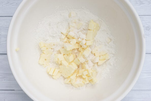 cubes of butter in a mixing bowl with flour.