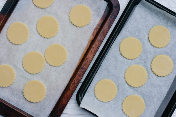 round biscuits cut out and placed on baking trays.