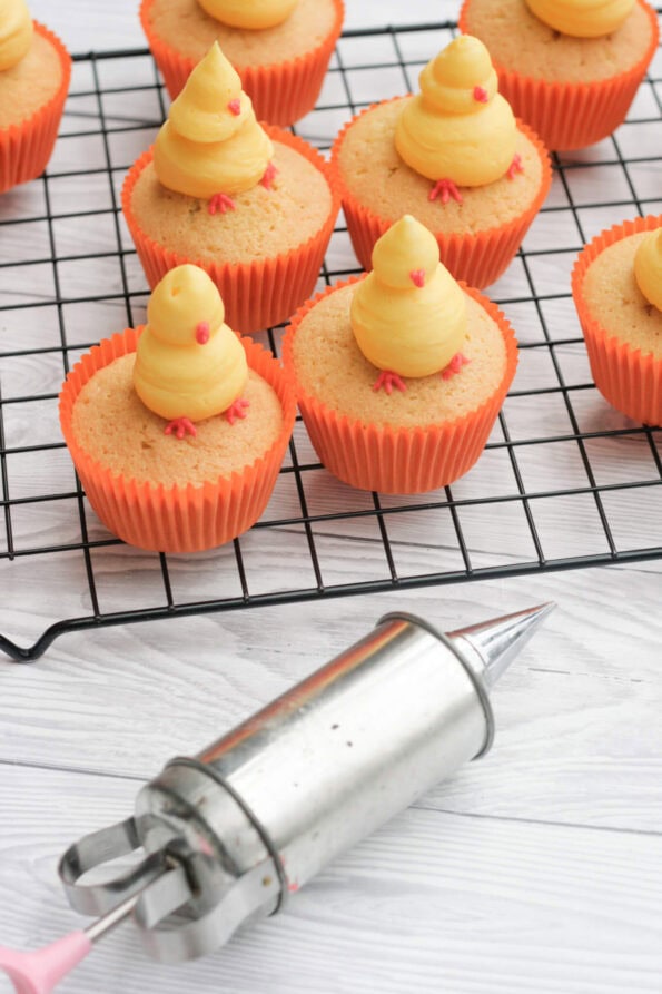 piping chicks onto cupcakes.