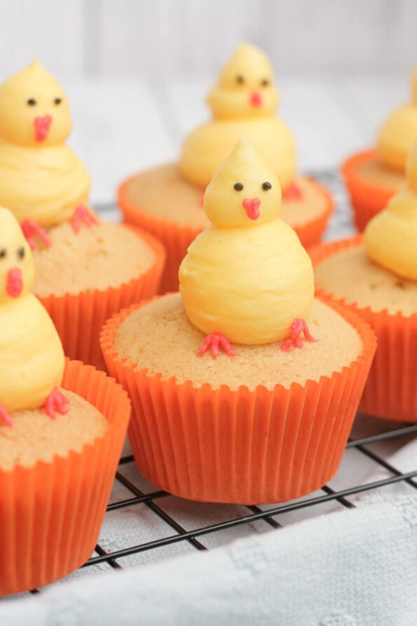 Easter chick cupcakes on a wire rack.