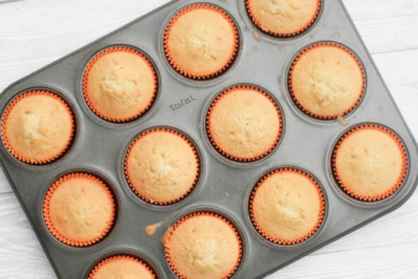 undecorated cupcakes in a muffin tin.