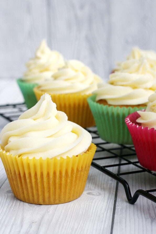 vanilla cupcakes on a wire rack