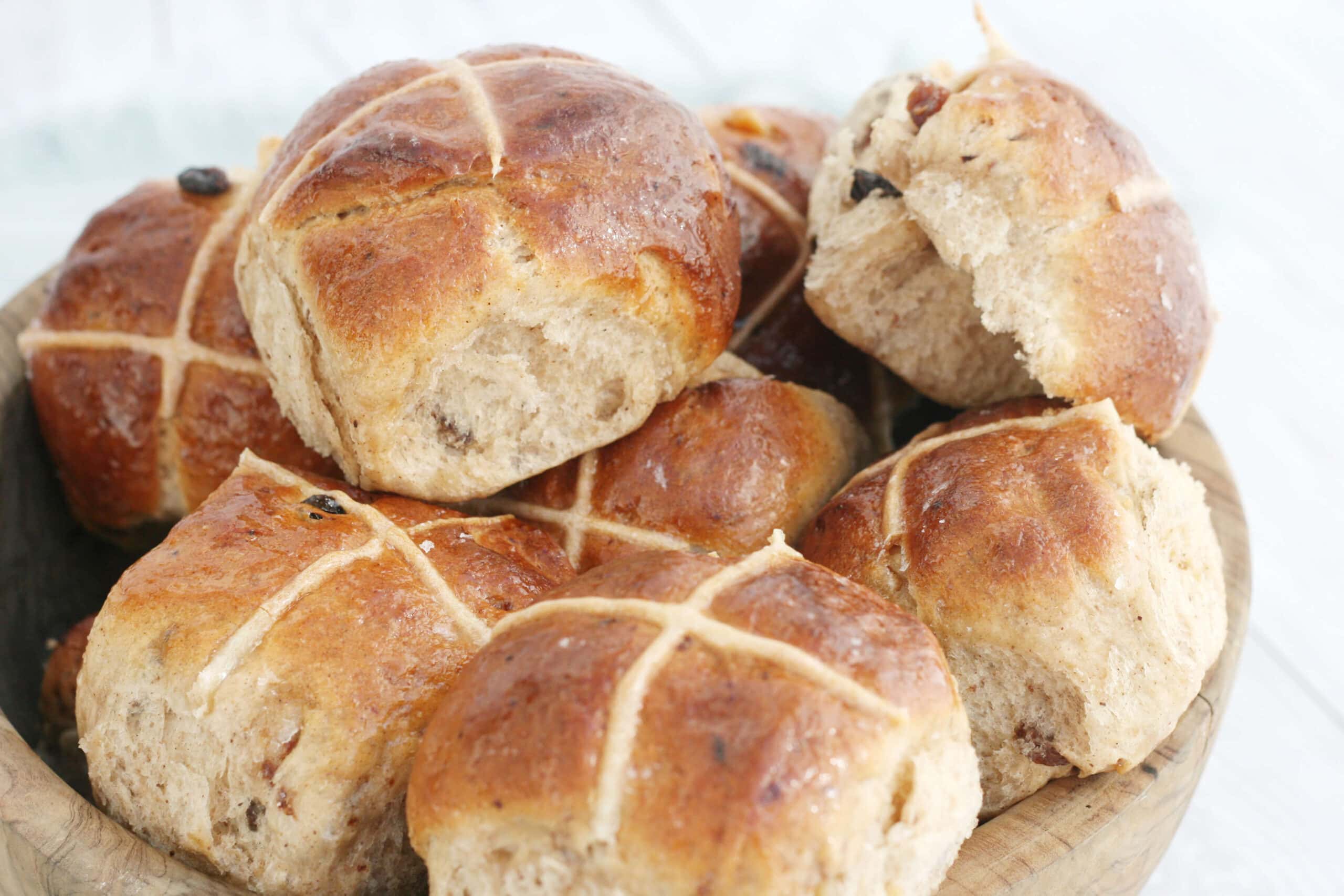 hot cross buns in a wooden bowl