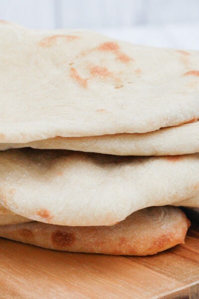 homemade pita bread on a wooden board.