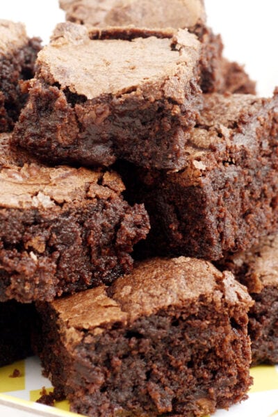 A stack of Mary Berry's chocolate brownies on a serving plate.