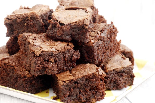 A stack of Mary Berry's chocolate brownies on a plate.