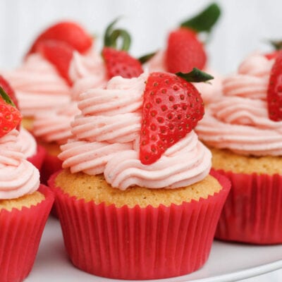 strawberry cupcakes on a cake stand.