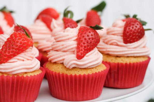 strawberry cupcakes on a cake stand. 