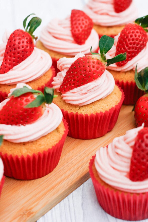 strawberry cupcakes on a wooden board. 