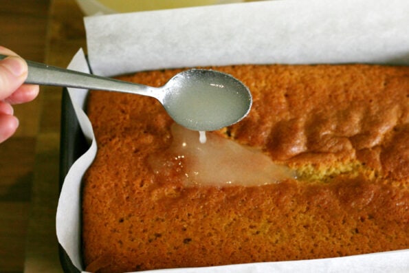 adding lemon drizzle to a loaf