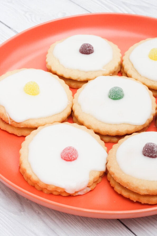 Empire biscuits on an orange plate. 