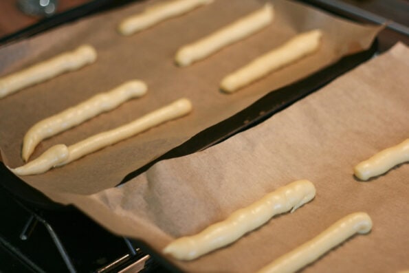 eclairs before being baked on two baking trays. 