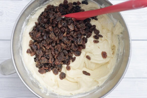 sultanas added to cake mix in a bowl.