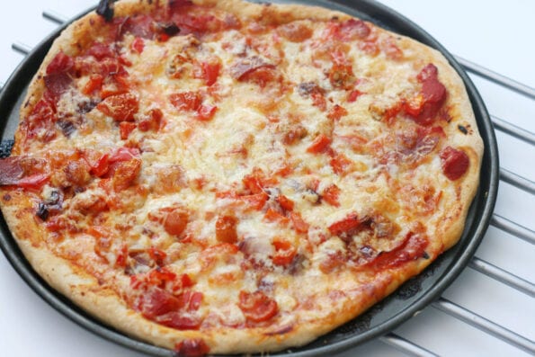 homemade pizza on a baking tray.