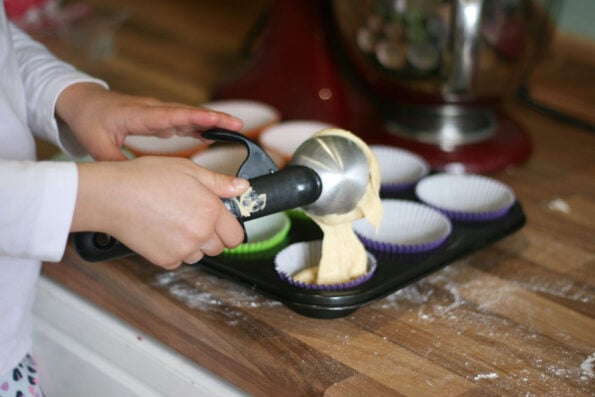 measuring out monster cupcake batter