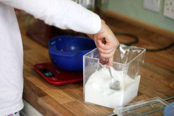 child measuring baking ingredients