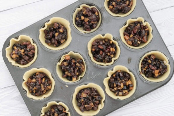mincemeat in pastry bases in a muffin tin.