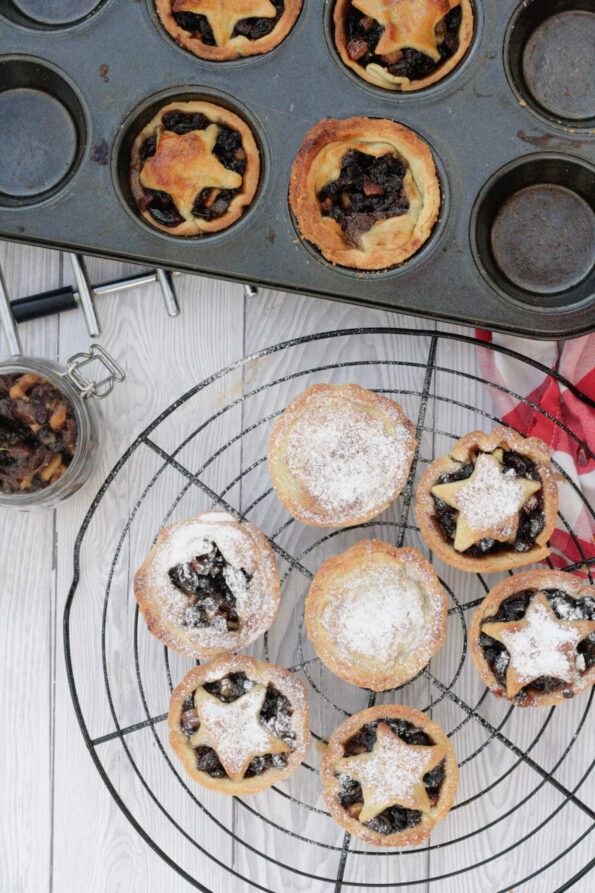 mince pies on a wire rack and baking tin.