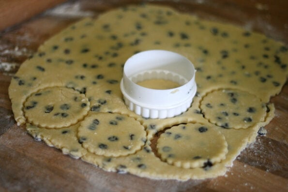 biscuit dough being cut with a cutter