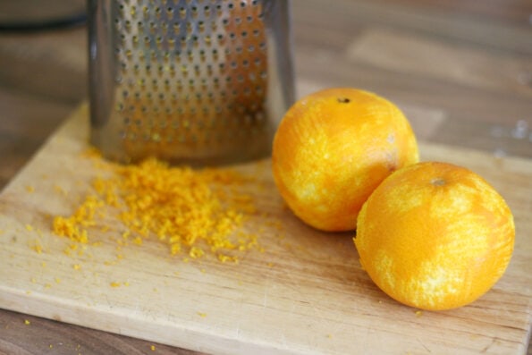 oranges zested next to a grater