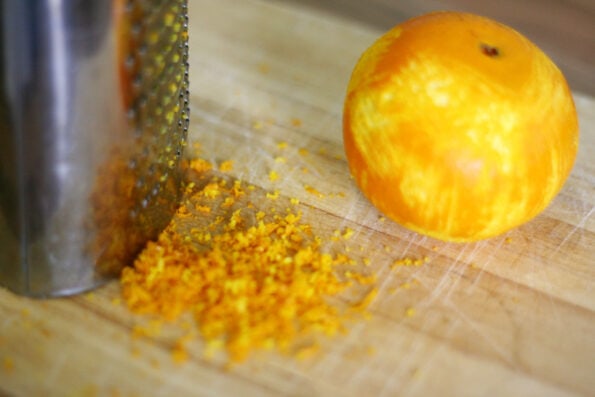a zested orange on a chopping board