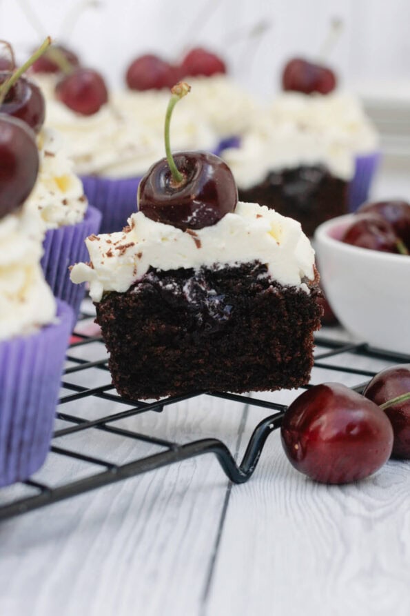 Black Forest cupcakes on a wire rack.