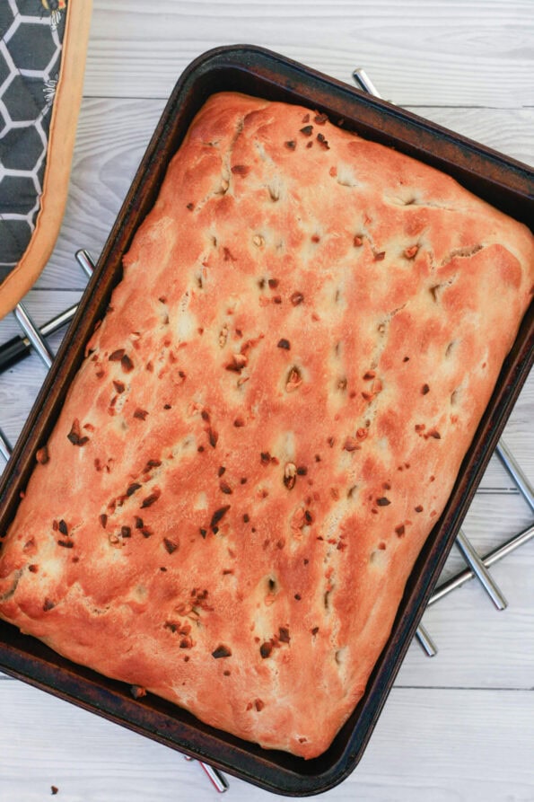 garlic focaccia on a baking tray.