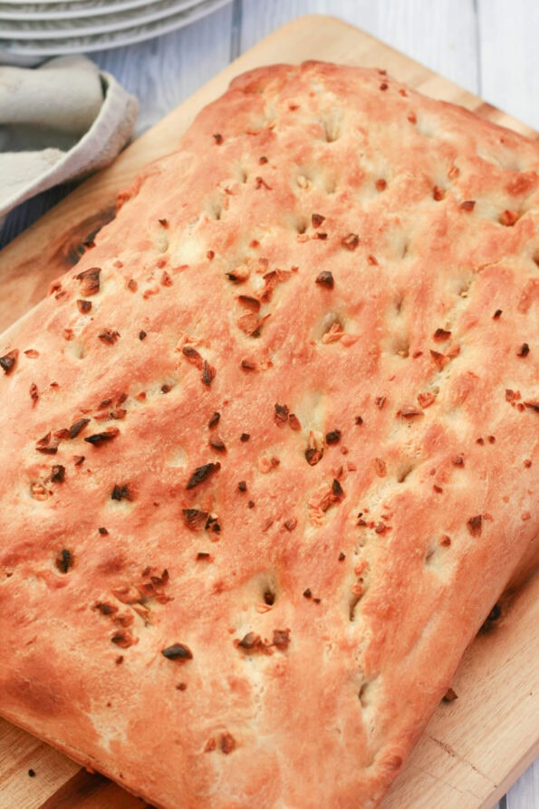 home garlic focaccia on a wooden board.