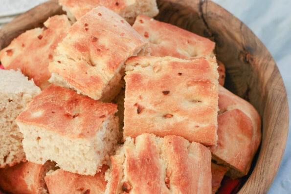 Pieces of garlic focaccia in a wooden bowl