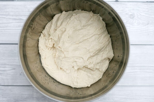 focaccia dough in a bowl being proved