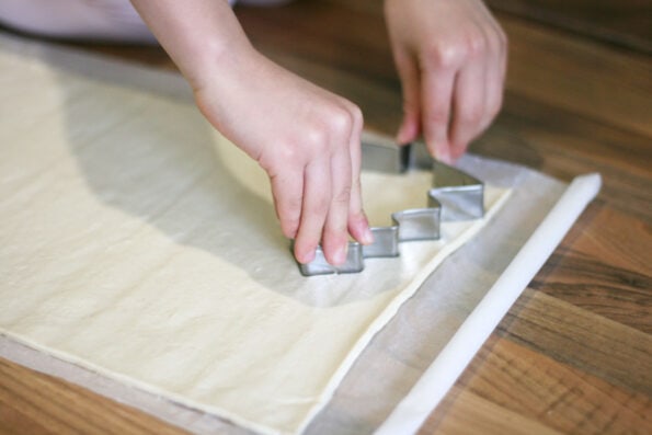 cutting out pizza bases with a christmas tree cutter