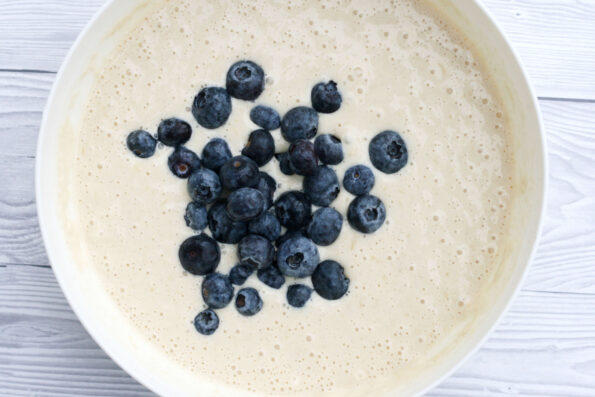 blueberries in pancake batter in a bowl