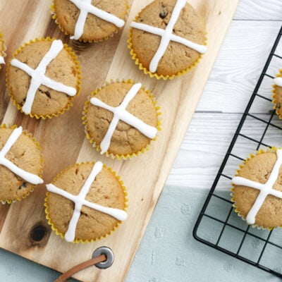 hot cross muffins on a wooden board