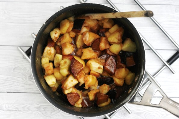 plums and apples in a pot