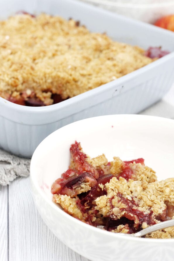 a serving of plum and apple crumble in a bowl