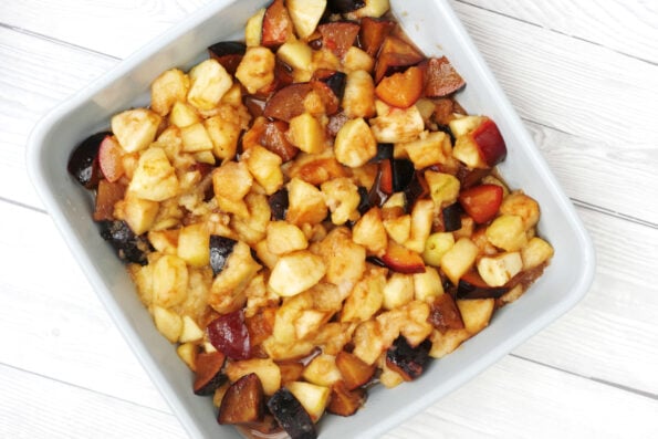 plums and apples in a dish