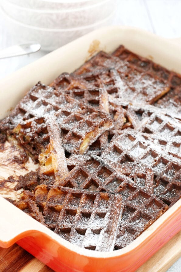 chocolate waffle pudding with icing sugar sprinkles on top.