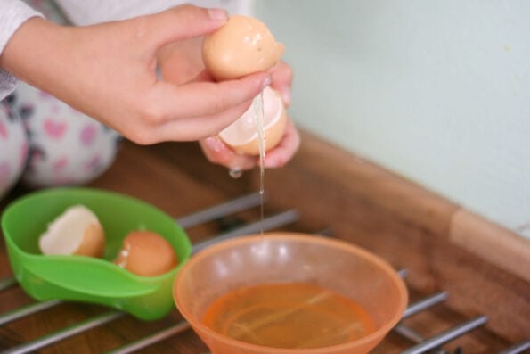 child separating egg yolks