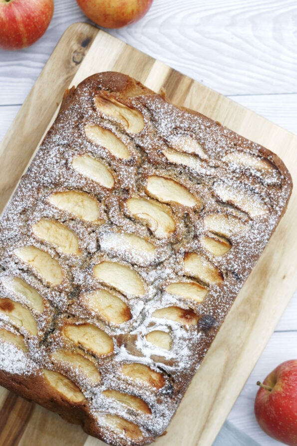 Mary Berry's apple cake on a wooden serving board.